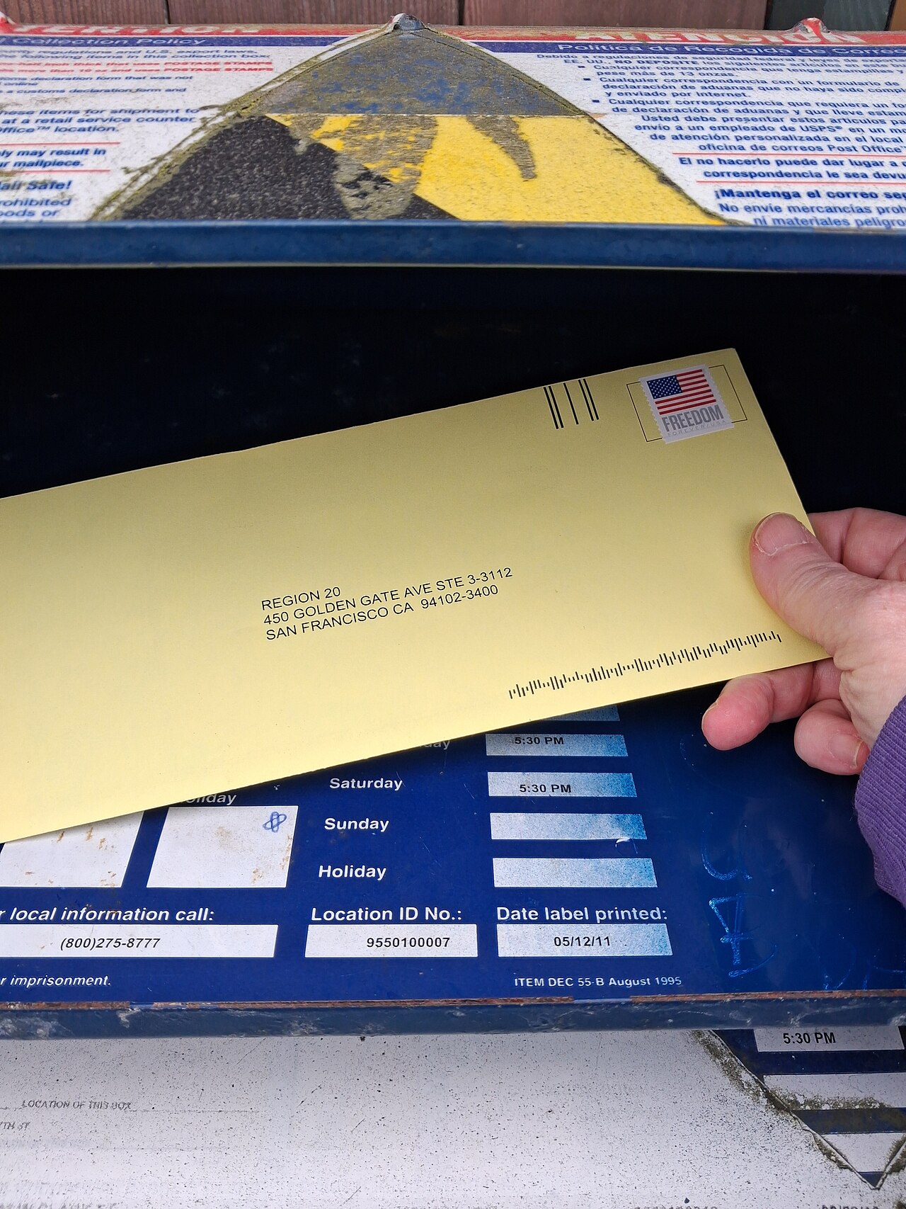 A voter's completed ballot is placed in the mail.